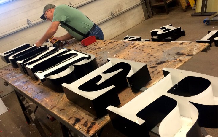 Custom channel letters under construction for a business sign in Santa Ana